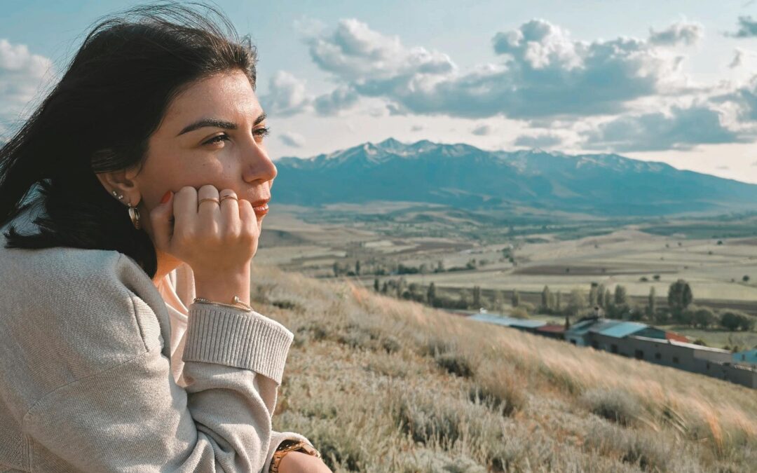 young woman pondering and looking out in the horizon