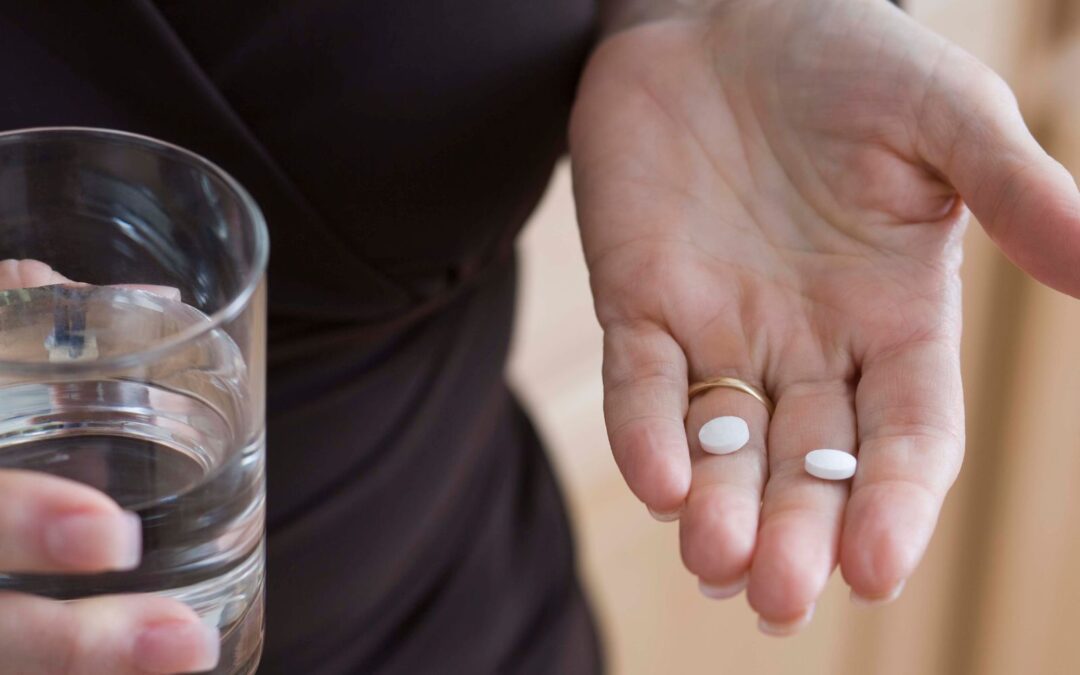 woman holding abortion pill in hands