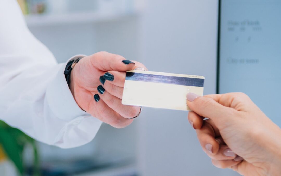 woman giving credit card to doctor